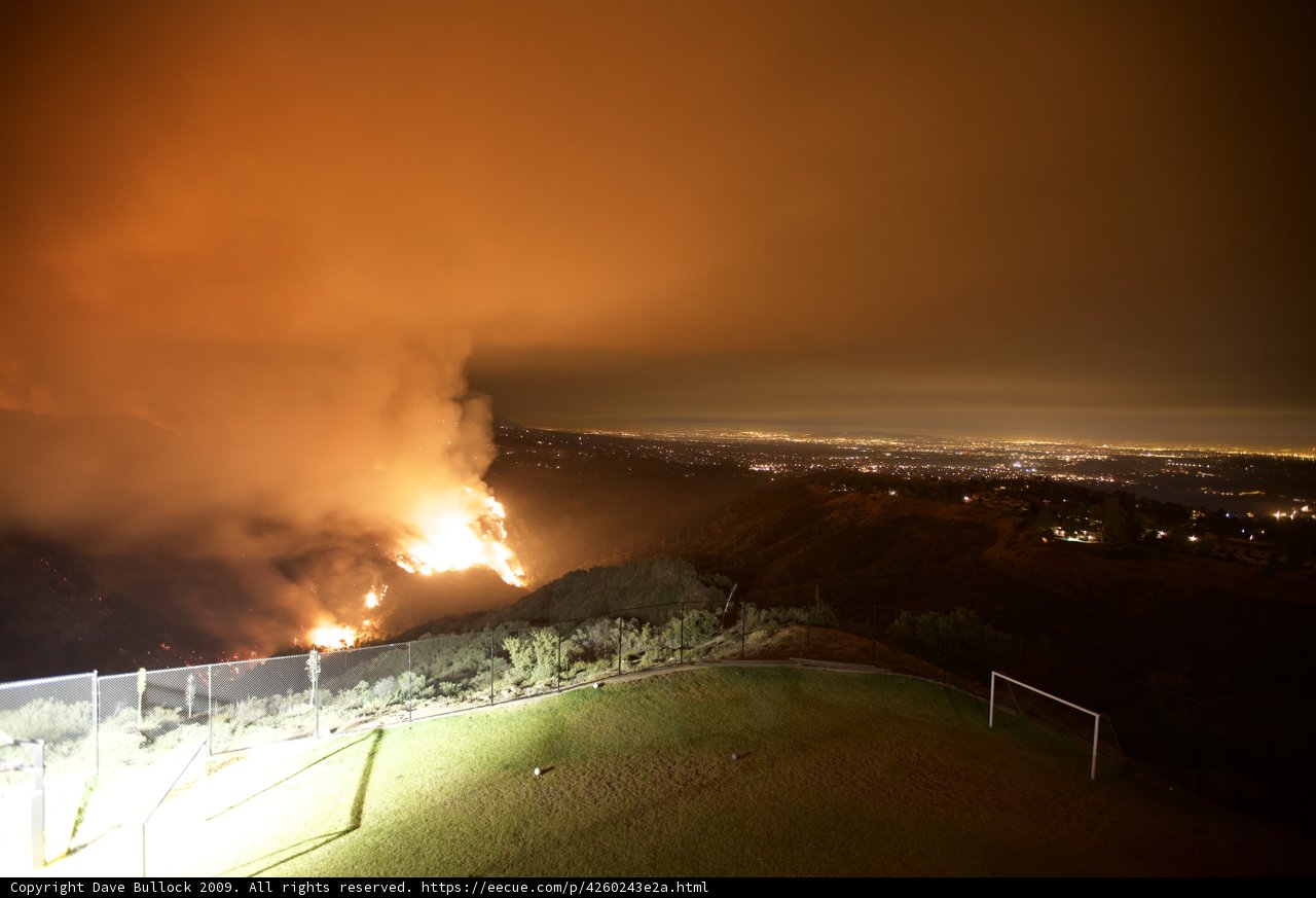 Flames engulf the hills at night