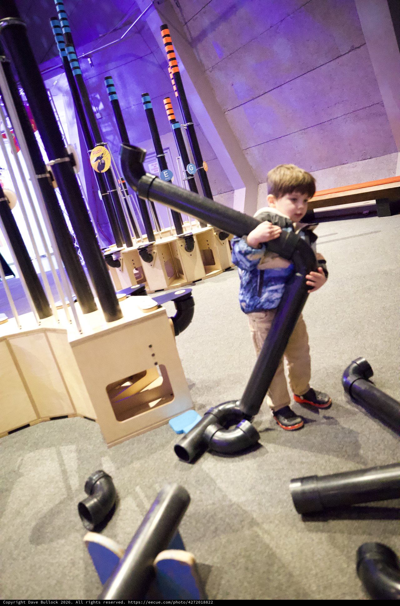 Child Playing with Pipes at Interactive Museum Exhibit