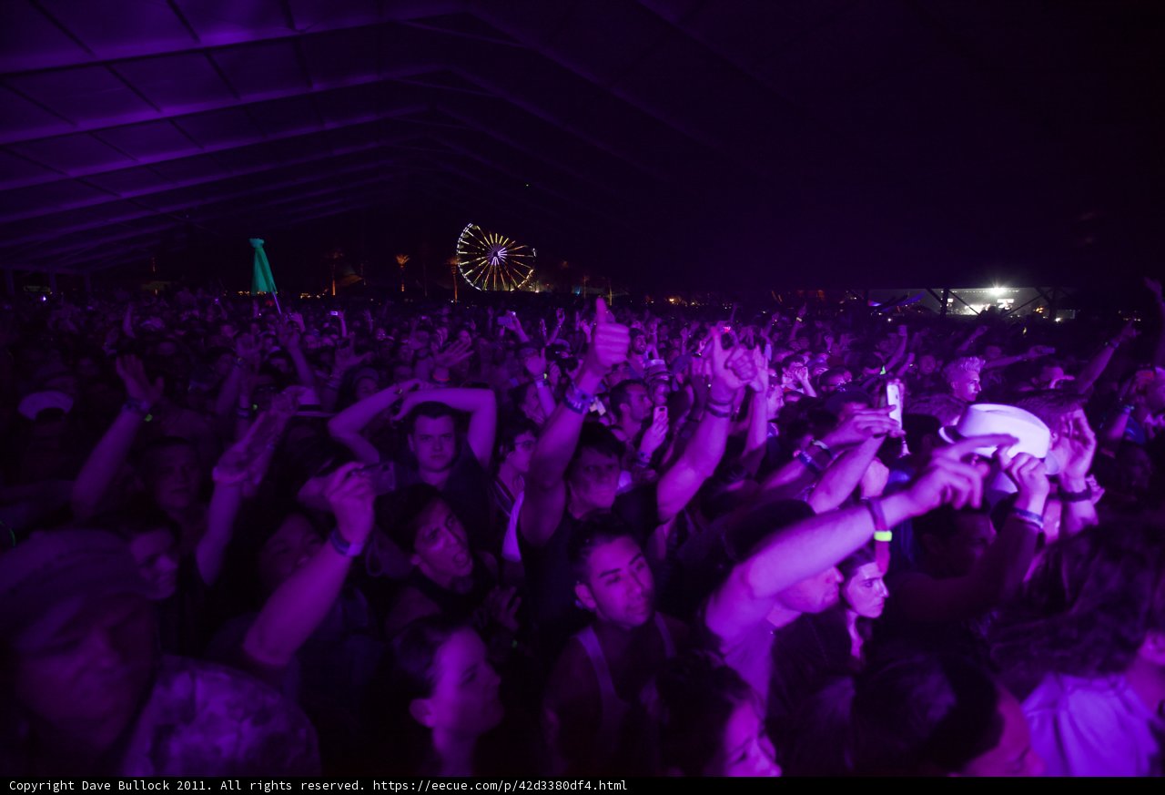 Coachella Crowd Goes Wild Caption: The energy in the air was electric as the crowd at Coachella pumped their hands in the air during the Friday night performance.