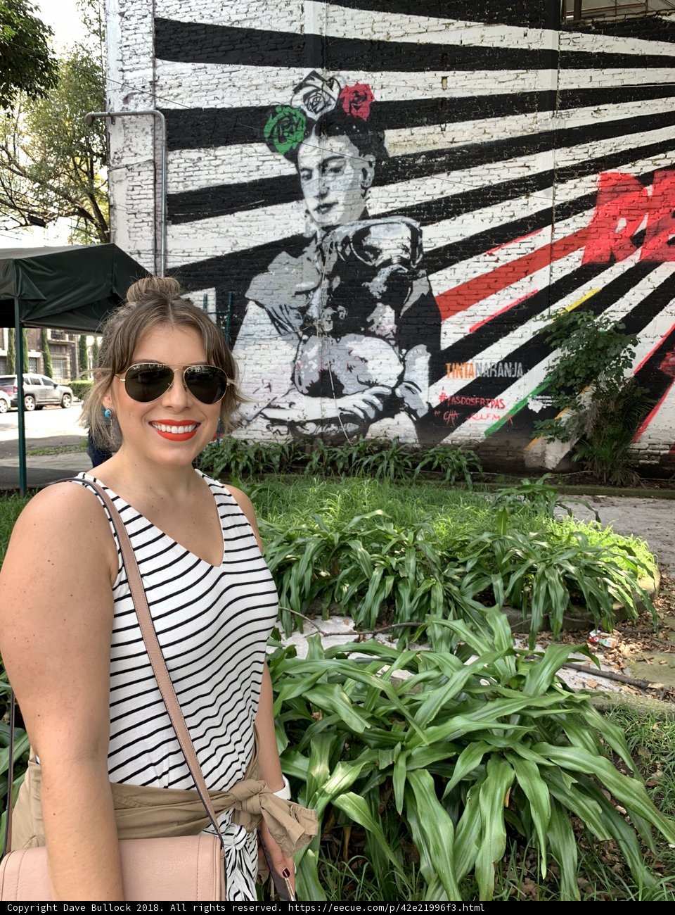 Portrait of a Woman in Front of a Colorful Mural
