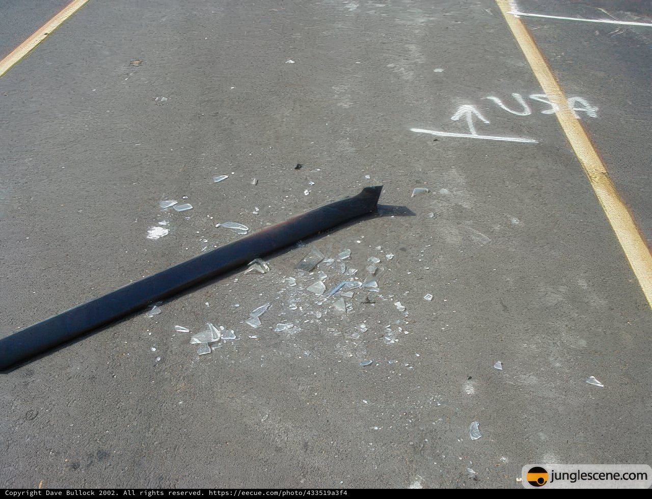 Broken Metal lying on Tarmac