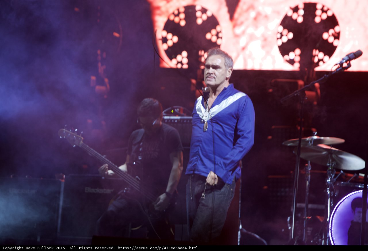 Morrissey Standing Hand On Hip Blue Shirt Bassist Drums Purple Haze Red Video Screen Lights