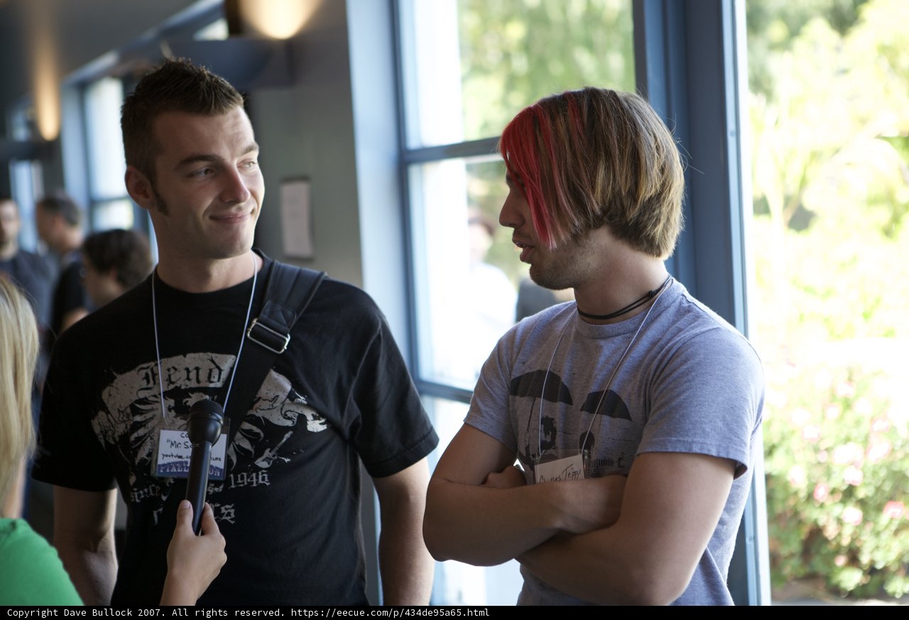 Man in Black T-Shirt Poses with Microphone at Film Festival