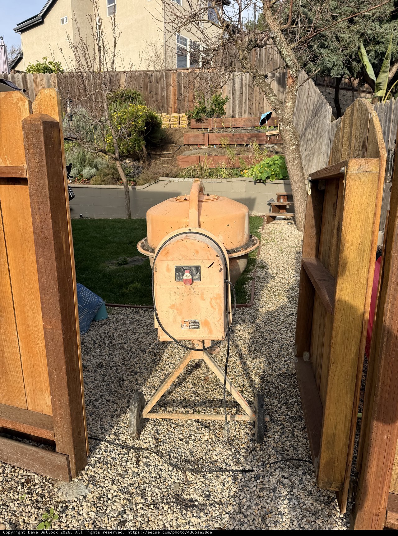 Vintage Orange Cement Mixer in Suburban Backyard