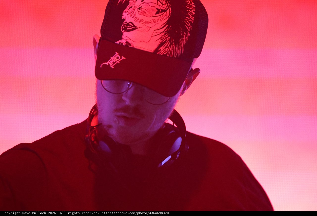 DJ Lost in the Mix Under Red Neon Glow