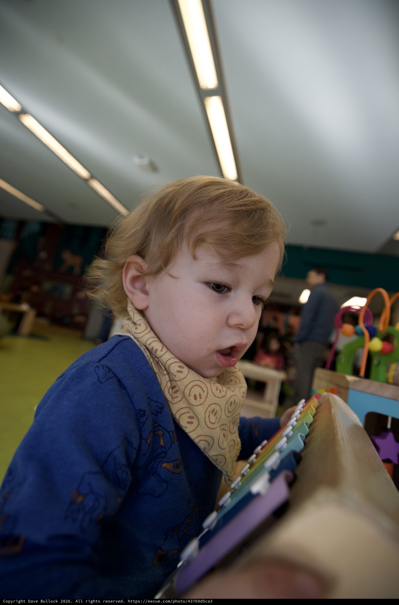 Young Child Reading Picture Book in Classroom