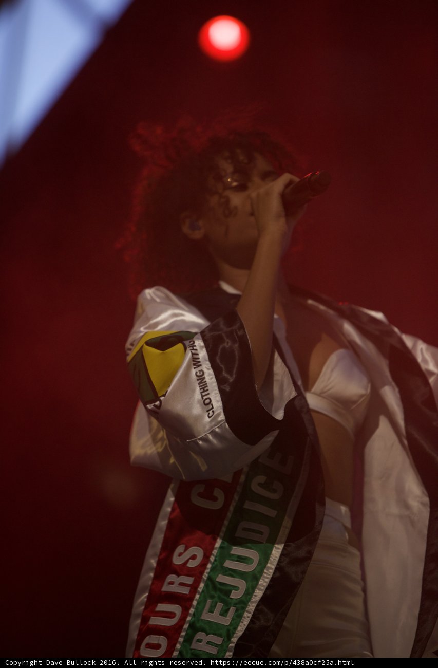 White-Shirted Woman Belts Out a Tune Under the Spotlight at Coachella