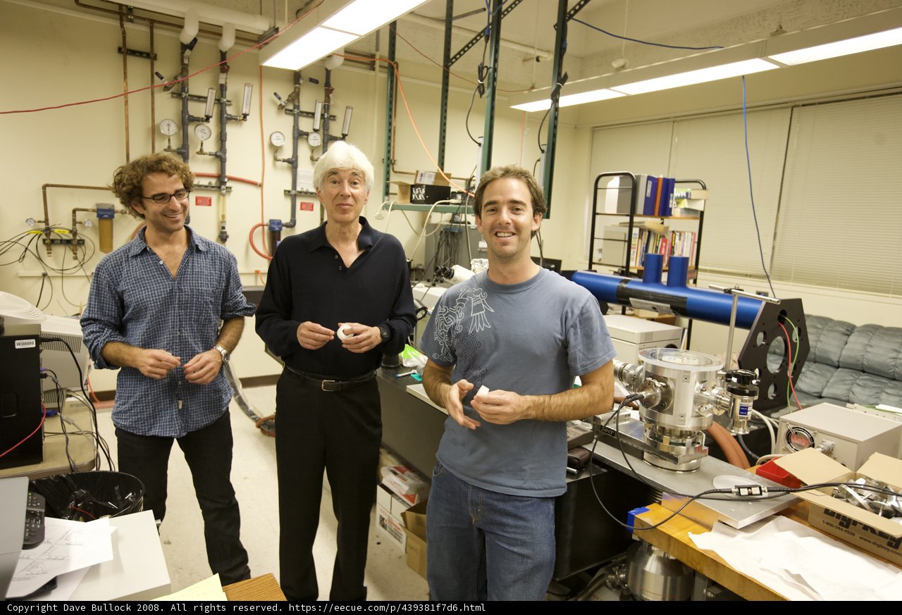 Three Men Conducting Experiments in a High-Tech Laboratory
