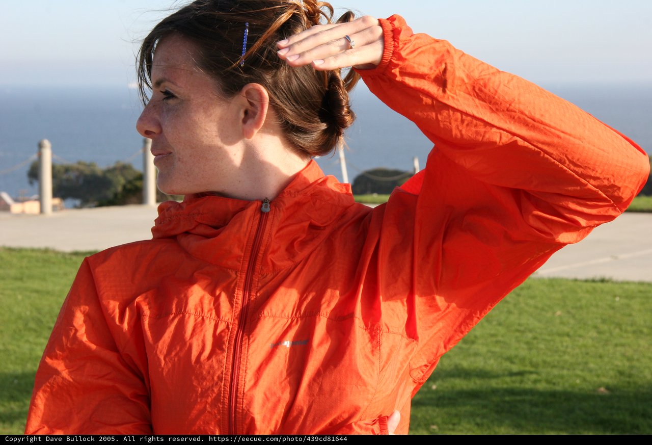 Woman in Orange Windbreaker by the Sea