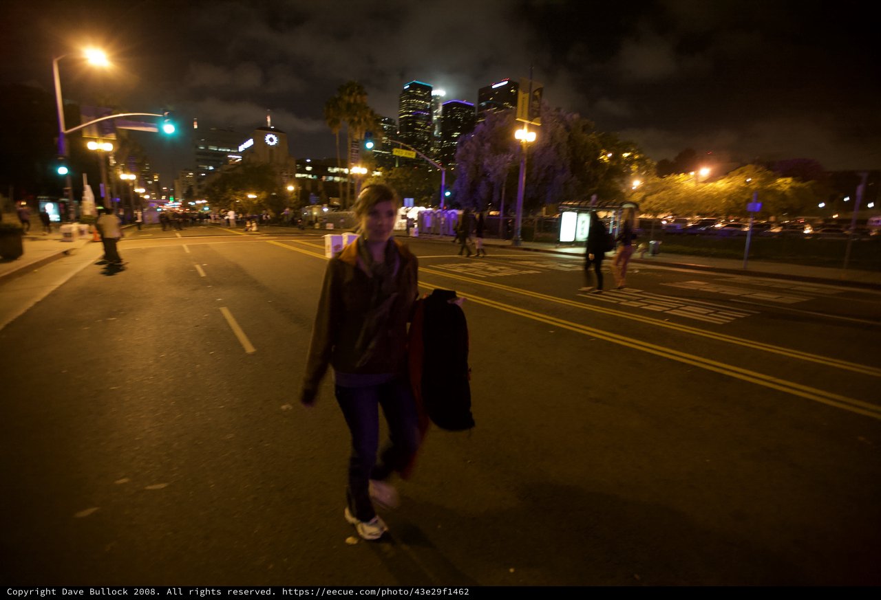 Night Walker on Empty Downtown Street at Dusk