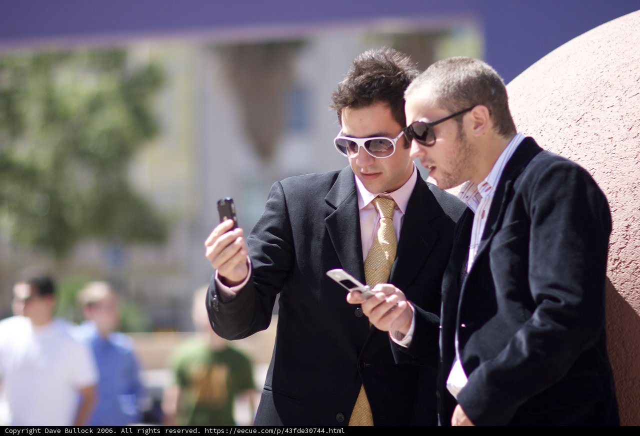 Businessmen Busy with Electronics