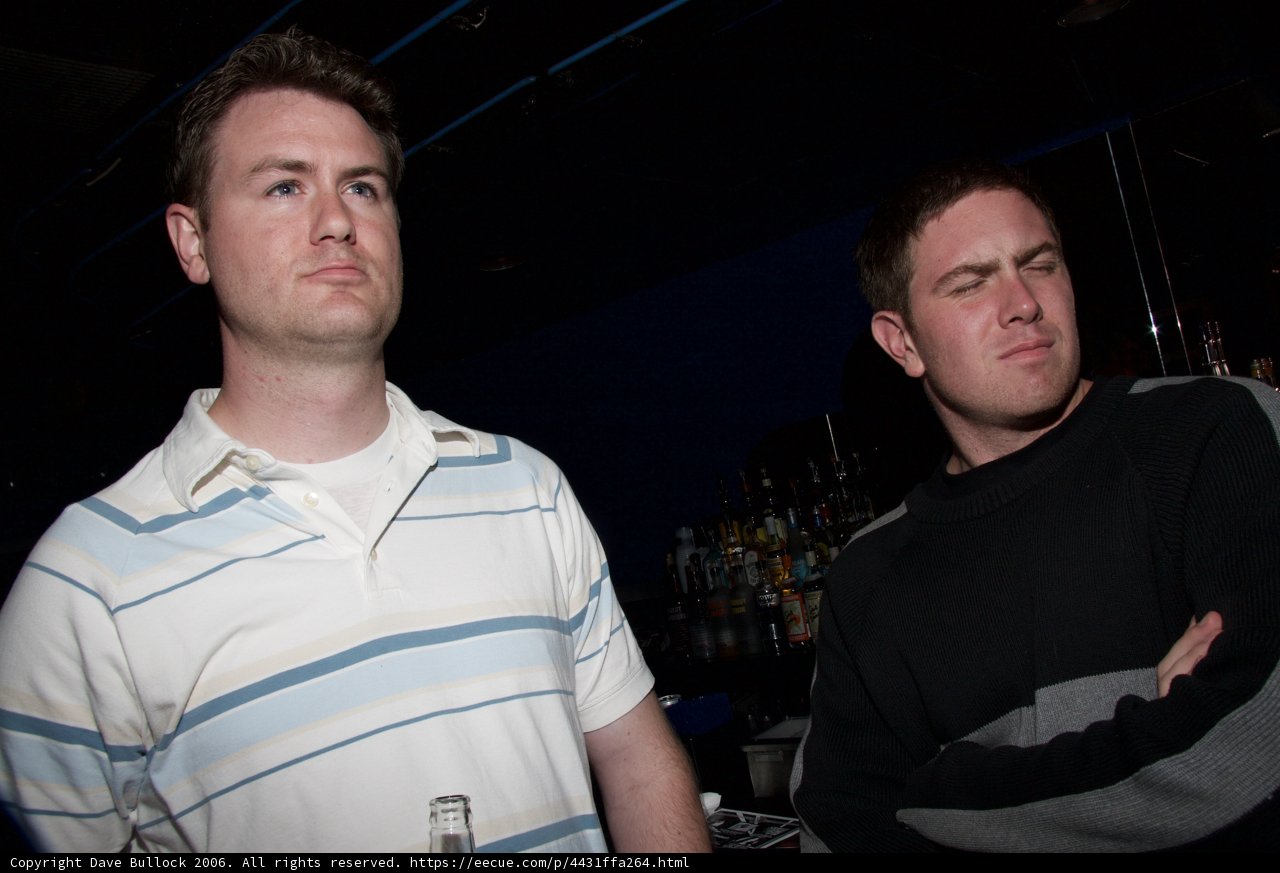 Two Men Enjoying Beer at the Local Pub