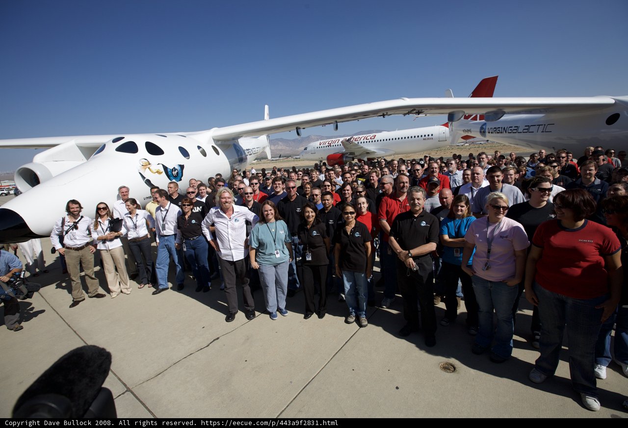 Group of Aviation Enthusiasts Poses in front of White Knight Two Airplanes