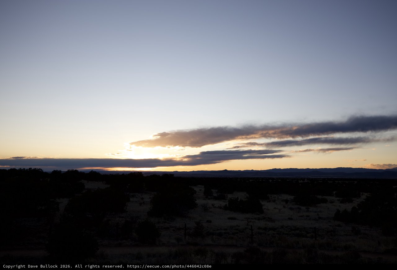 Dramatic Desert Sunset Over Distant Mountain Range
