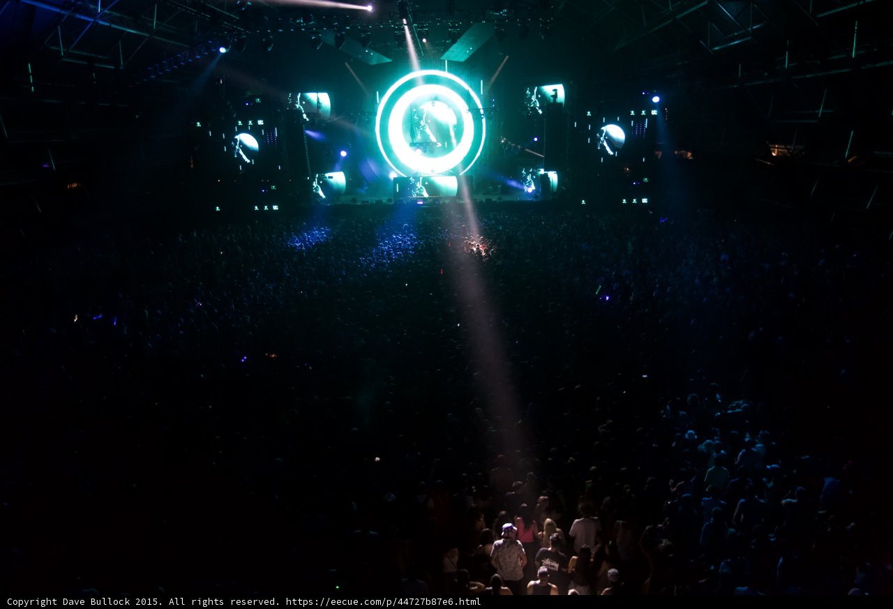 Green Spotlight Shines Down on Concert Crowd