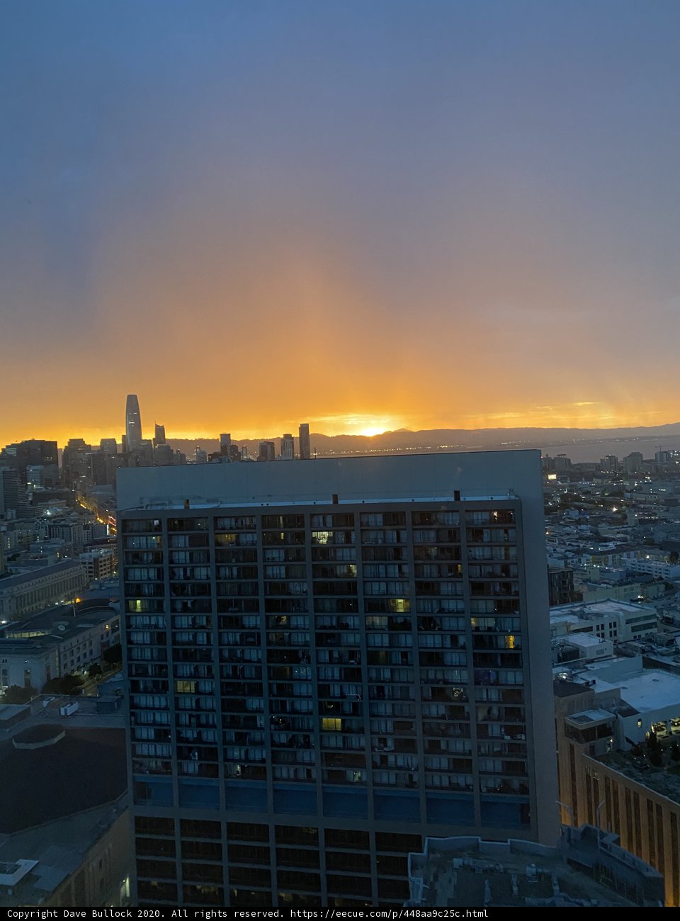 Skyline at Sunset Caption: A stunning view of San Francisco's cityscape at sunset, with towering skyscrapers and vibrant orange and blue hues filling the sky over the urban metropolis.
