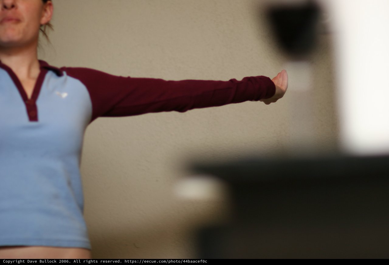 Woman Extends Arm in Dynamic Indoor Pose