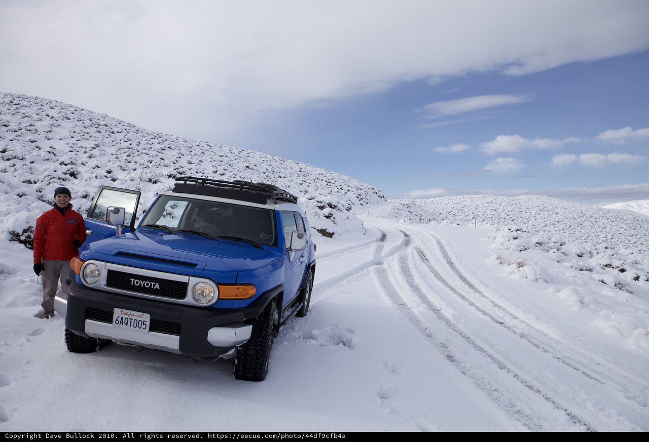 Blue FJ Cruiser Adventure on Snow-Covered Mountain Road
