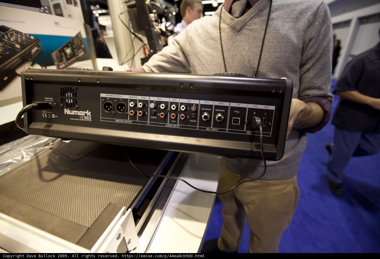 Man Holding Amplifier in Electronics Room