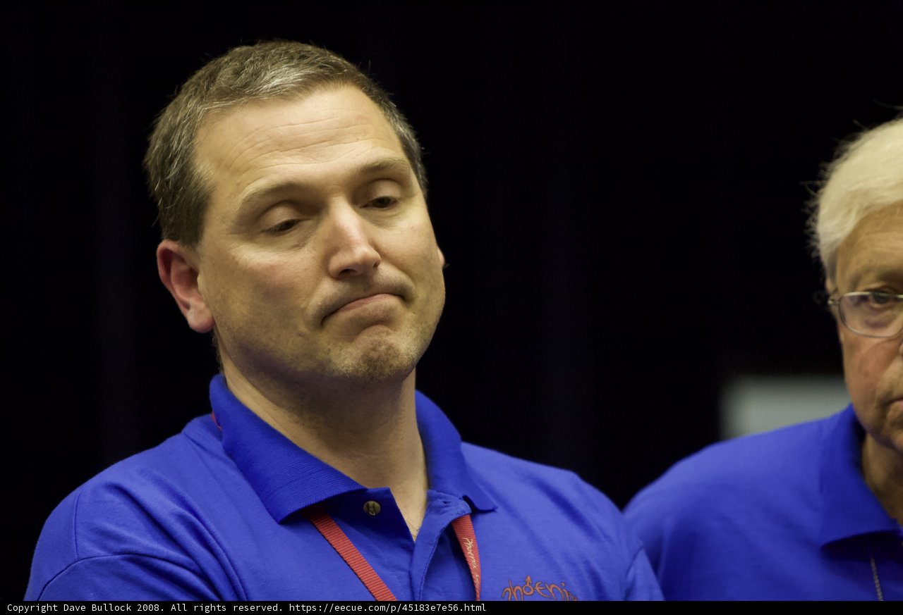 Two Men in Blue Shirts Stand for Post-Interview Photograph