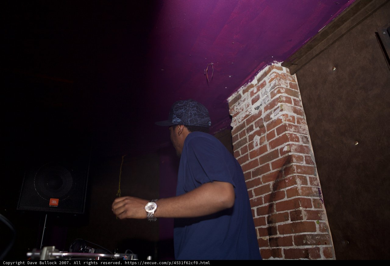 The Blue-Clothed Entertainer in Front of the Brick Wall