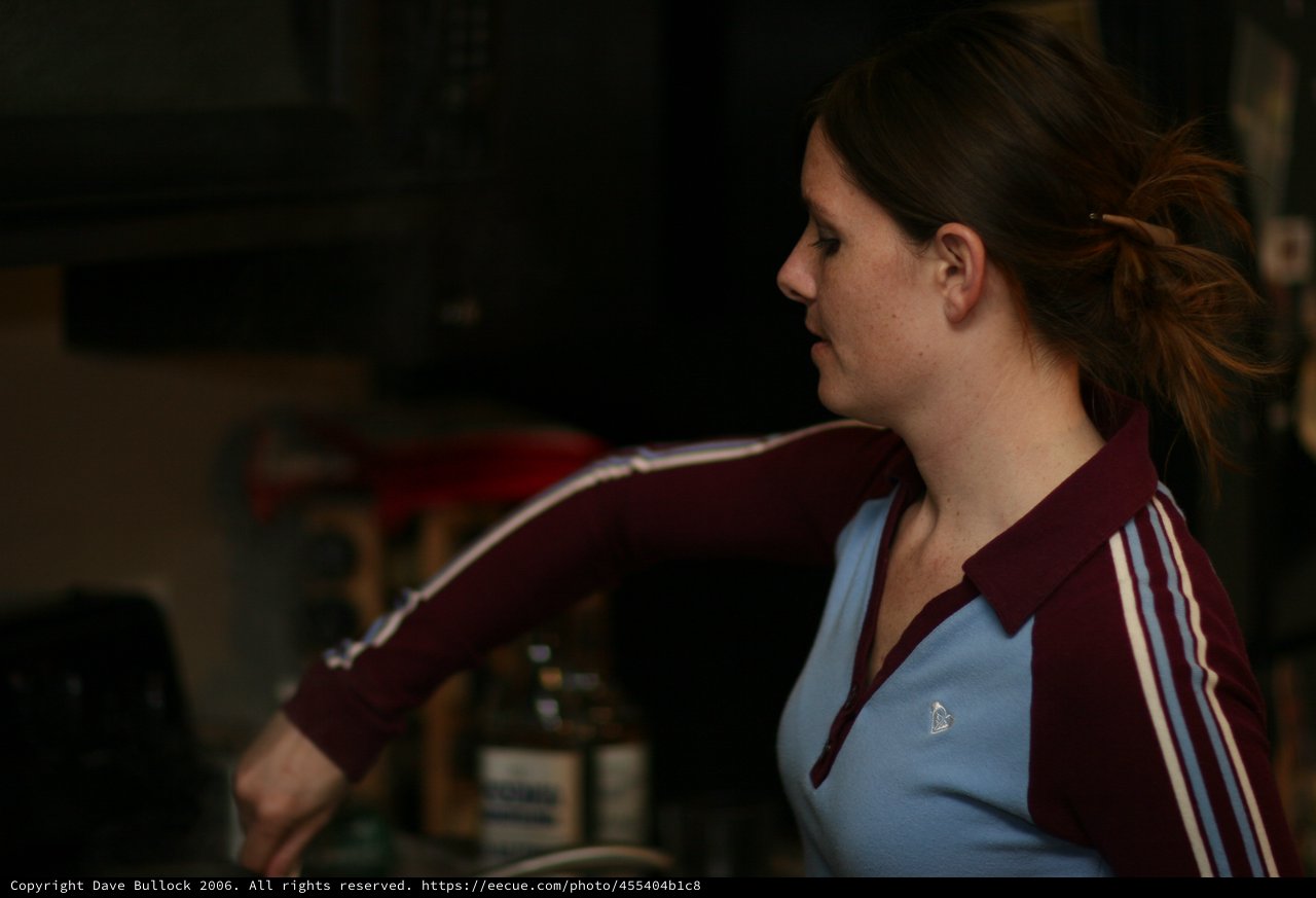 Woman in Retro Tracksuit at Casual Indoor Gathering