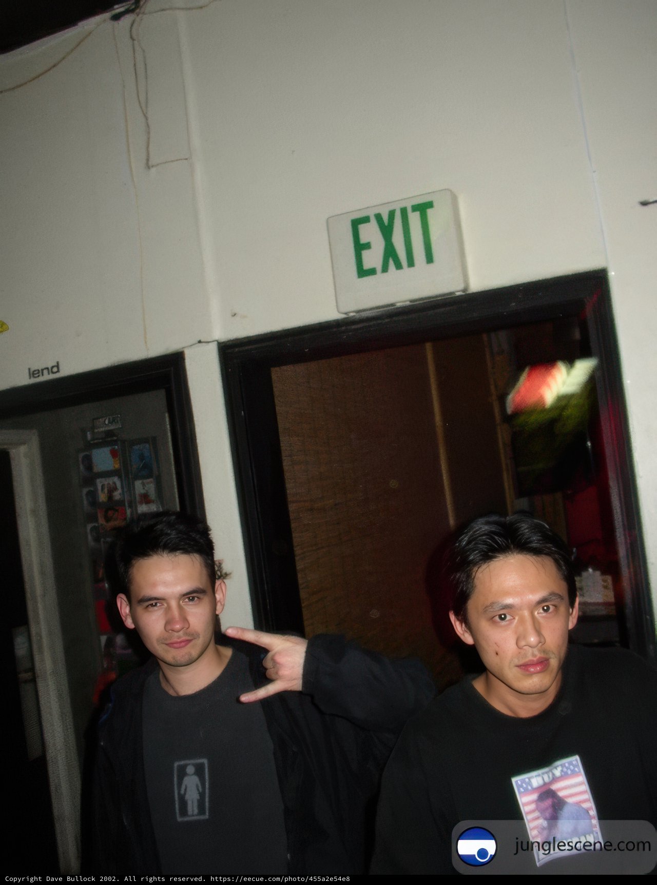 Two Men Posing in Front of a Door