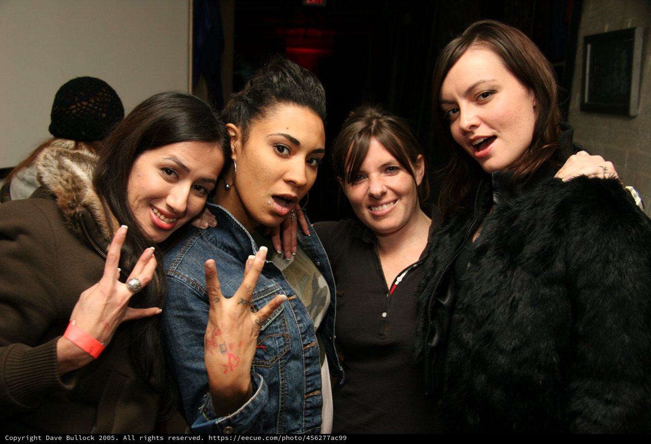 Four Friends Posing Together at a Night Venue