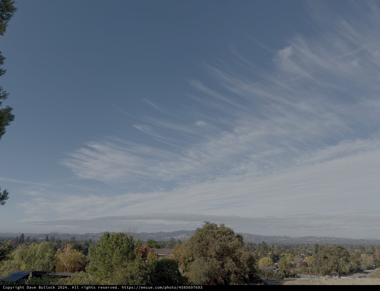 Suburban Valley View with Wispy Cloud Formations
