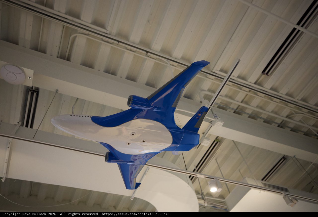 Blue Fighter Jet Model Suspended from Museum Ceiling