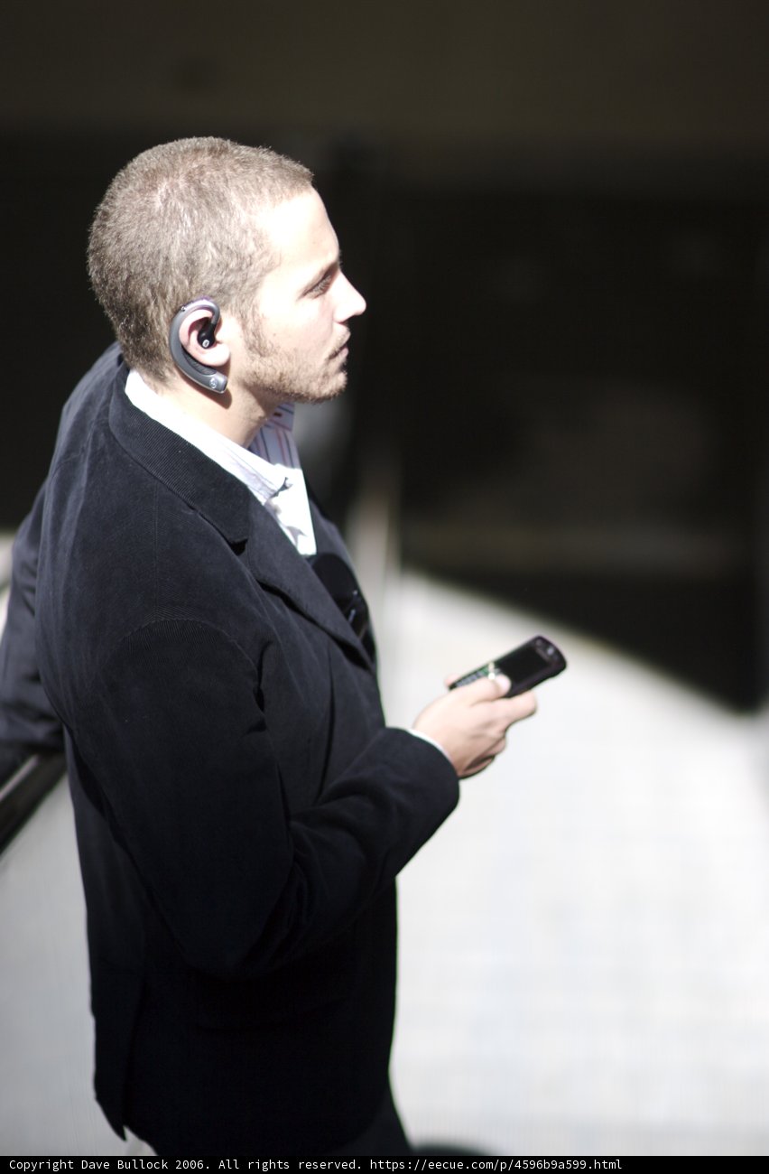 Businessman on the Phone Caption: A suited man stays connected with his cell phone during a business shoot for Flexilis.