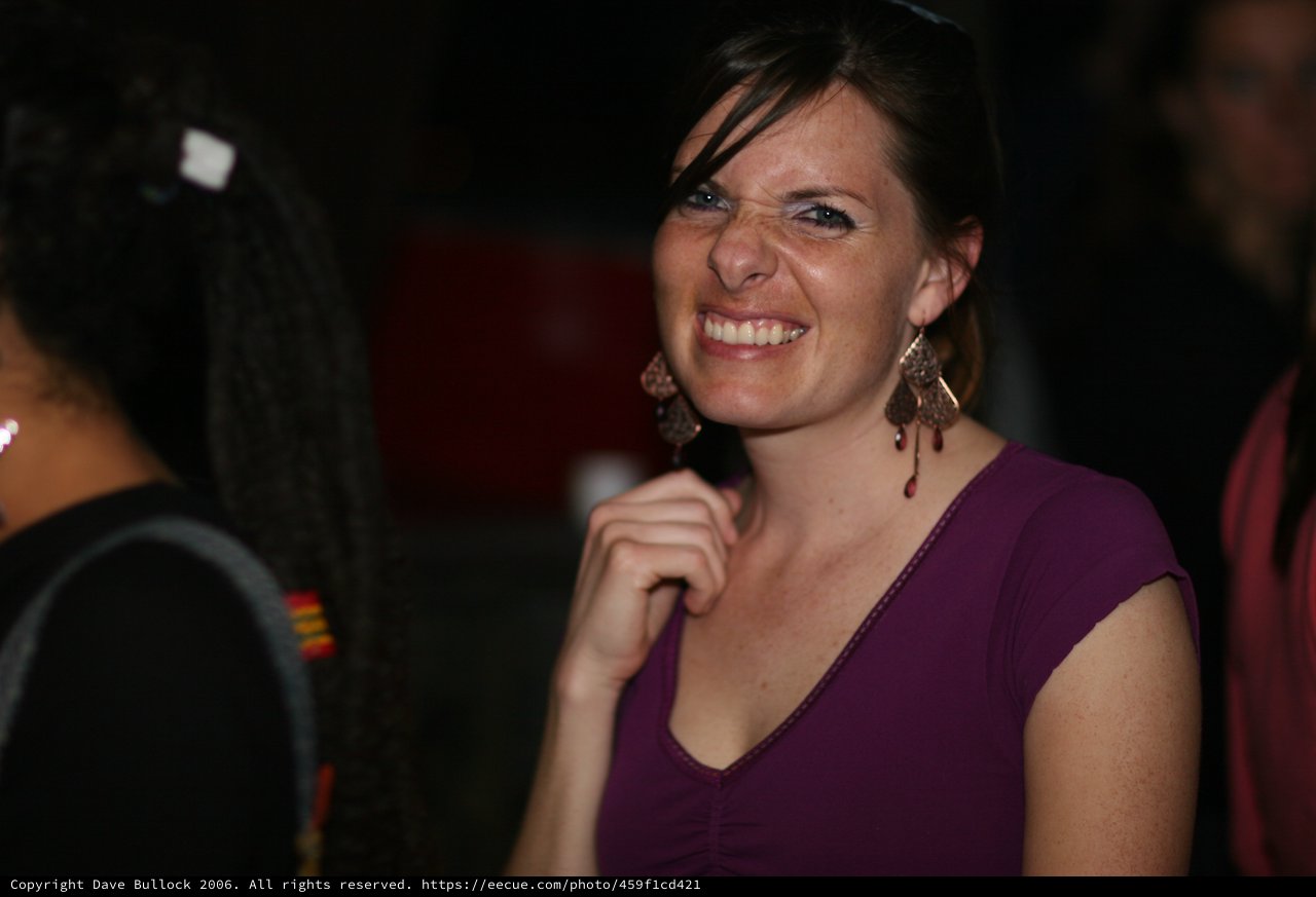 Joyful Woman Smiling at Evening Social Gathering