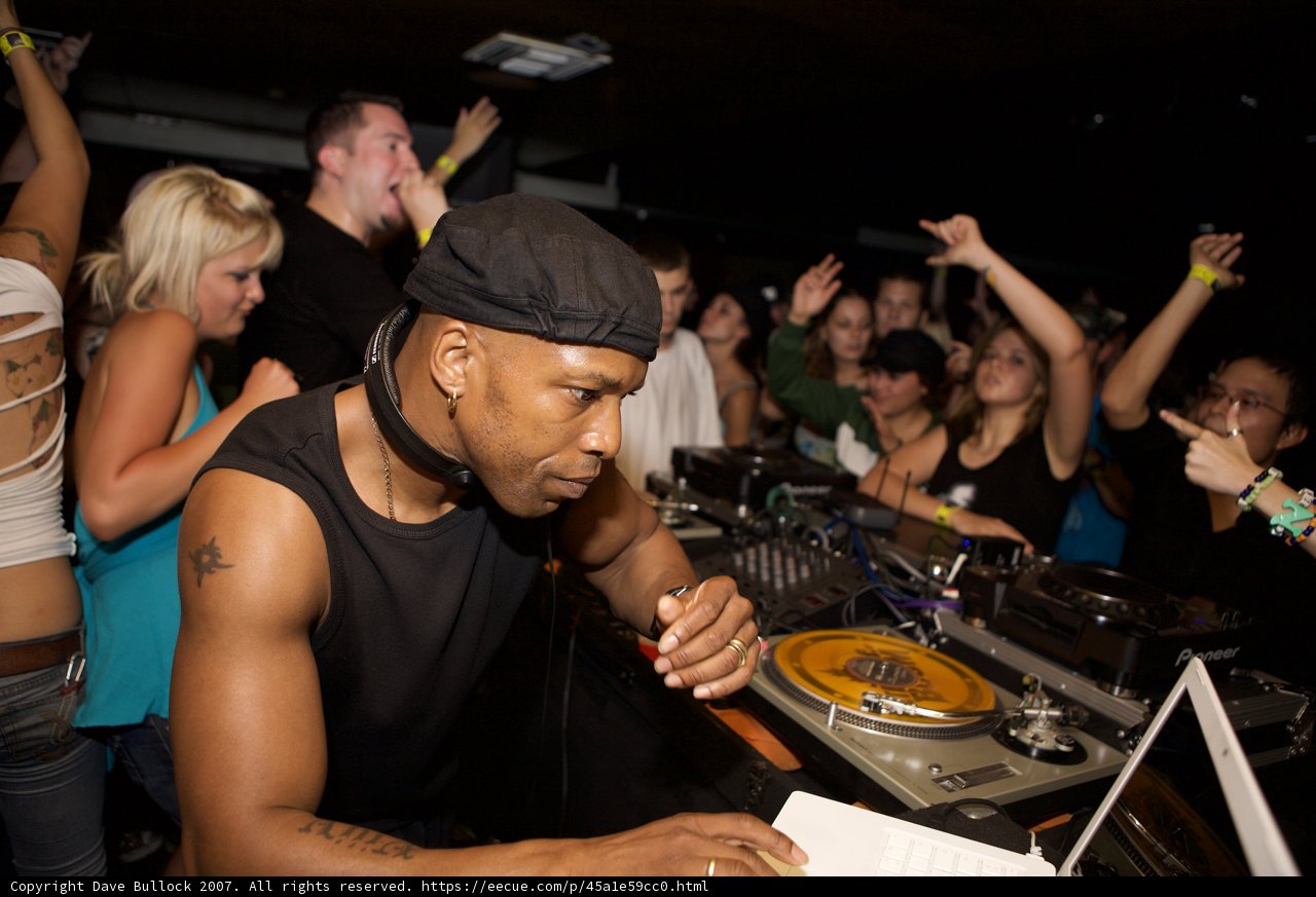 Nightclub Entertainer in Black Tank Top and Baseball Cap