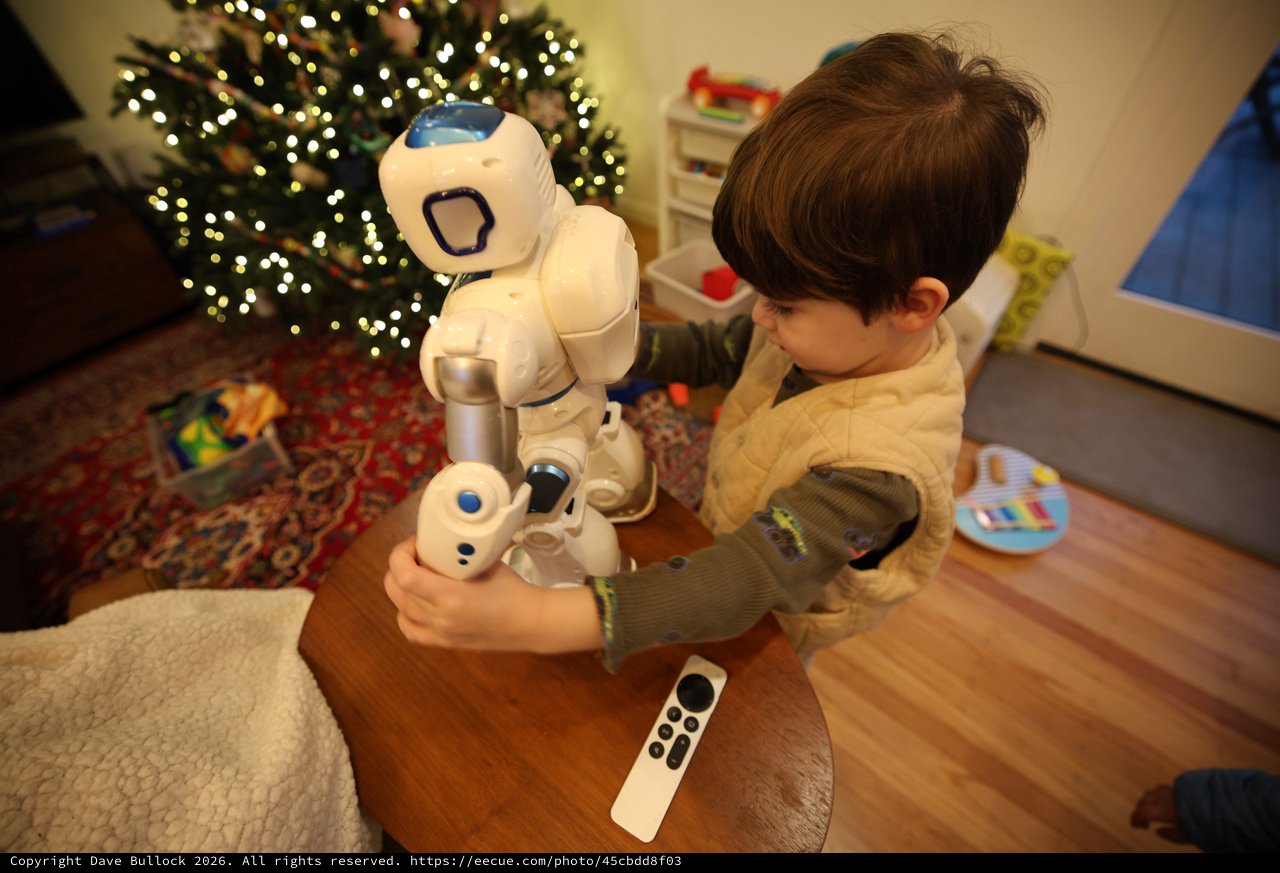 Child Interacting with Humanoid Robot on Christmas Morning