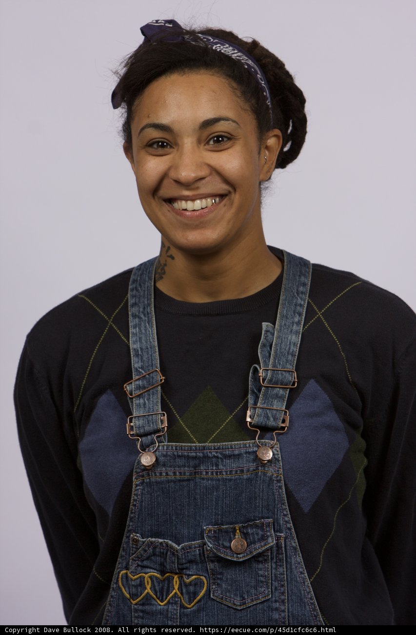 Smiling Woman in Overalls and Headband