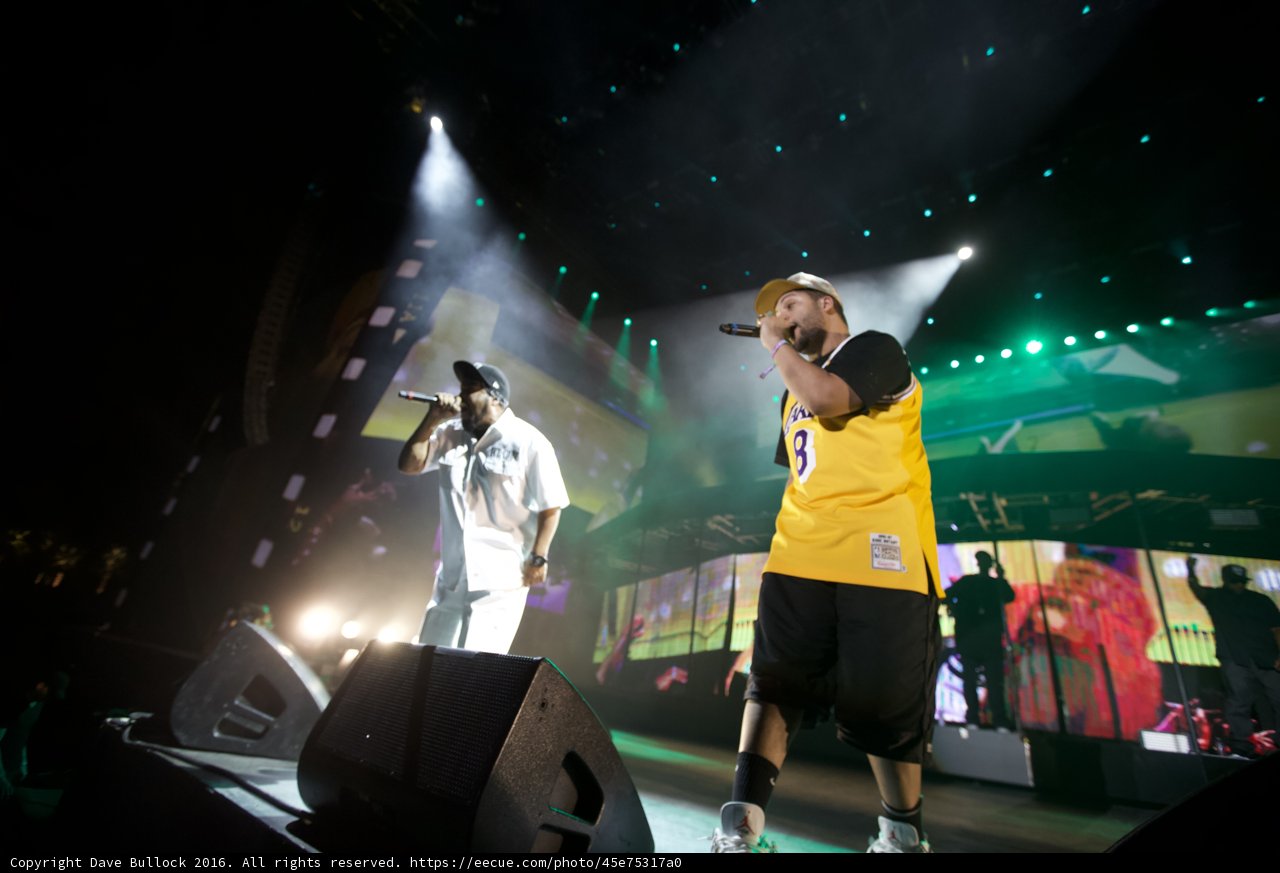 Rocking the StageCaption: Two male performers light up the stage and captivate the crowd during their musical performance at Coachella 2016. The speakers and spotlights add to the electrifying atmosphere of the concert.
