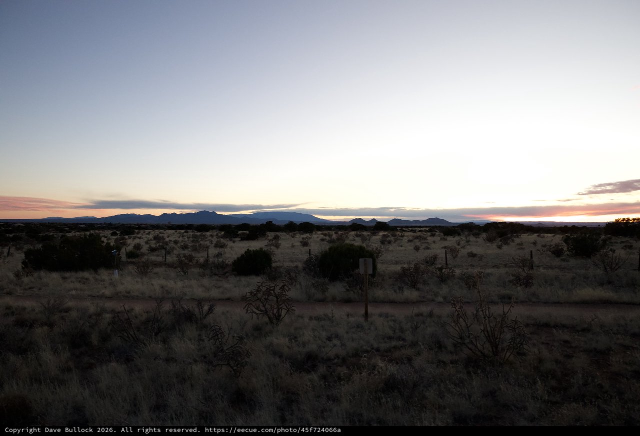 Desert Twilight Over Distant Mountain Ranges