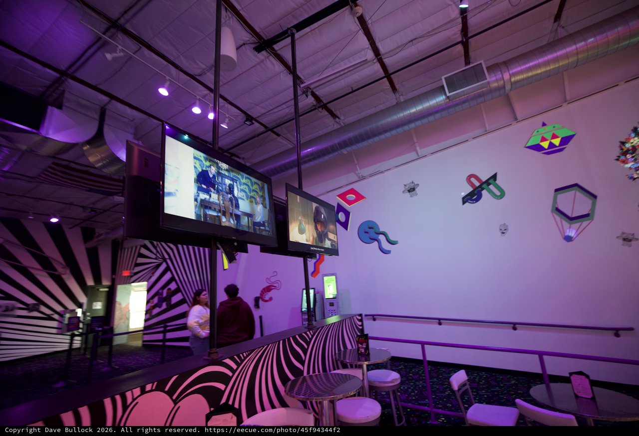 Modern Interactive Gaming Museum with Purple Ambient Lighting