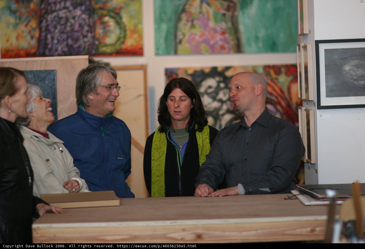 Art Enthusiasts Admire Wood-Framed Paintings