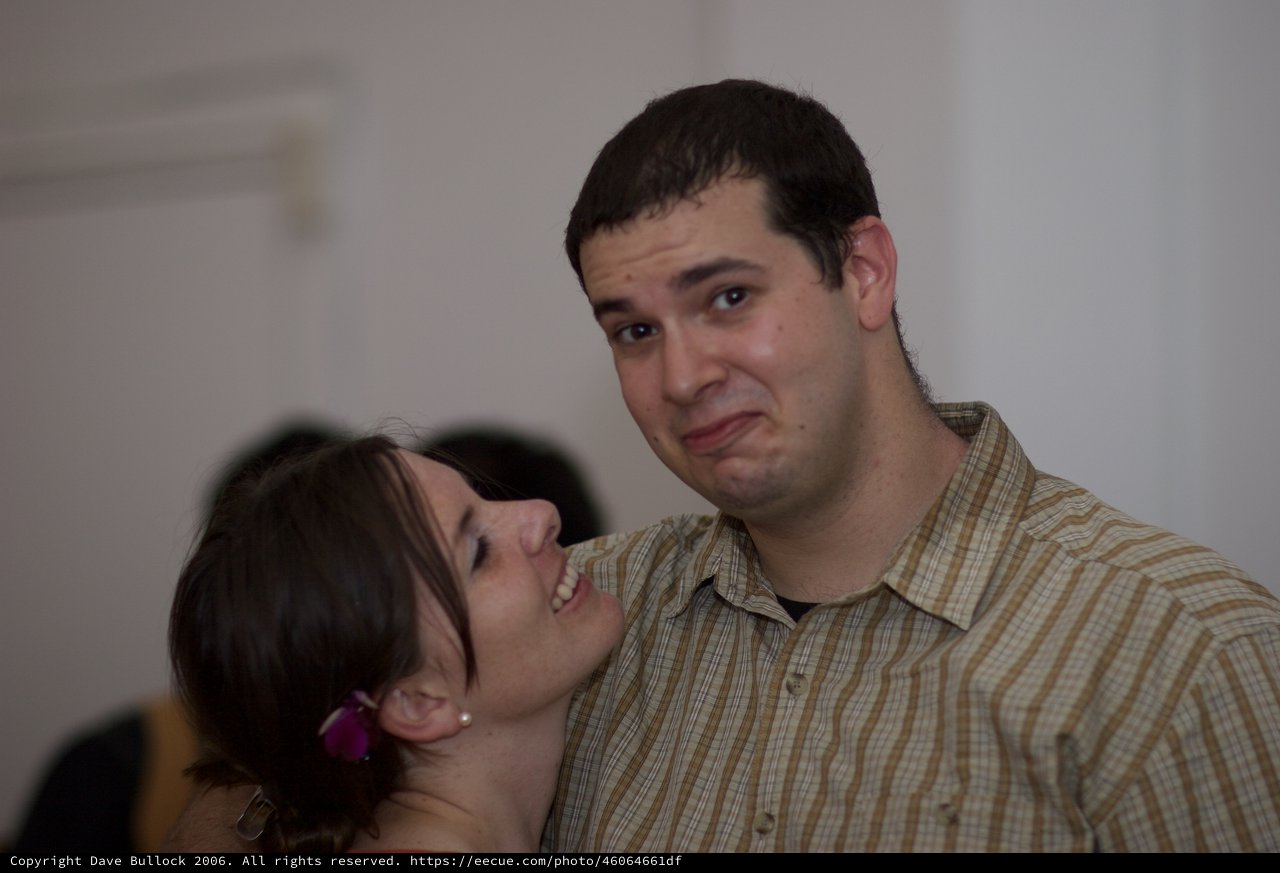 Couple Shares Playful Moment at Social Gathering
