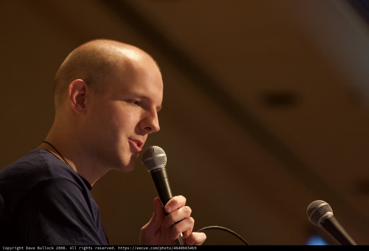 Bald Entertainer Performing with a Microphone