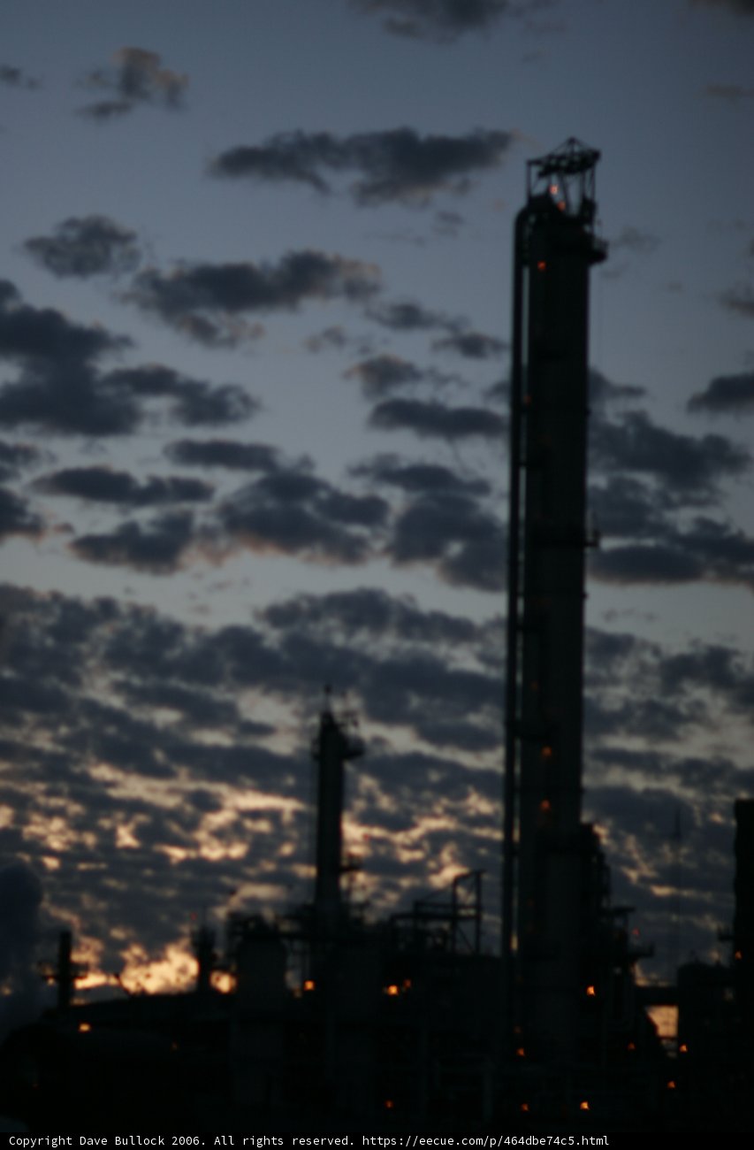 Fiery Silhouette: A Sunset View of a Large Oil Refinery