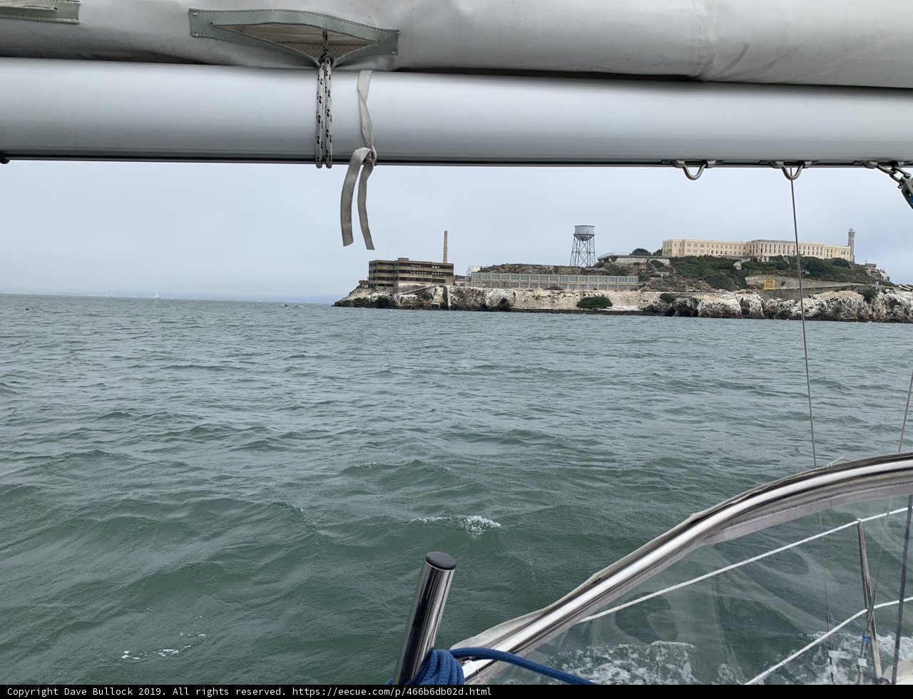 Sailboat sailing towards Alcatraz Island Lighthouse