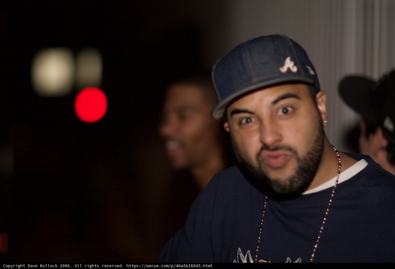 Blue-shirted Man with Double Hats