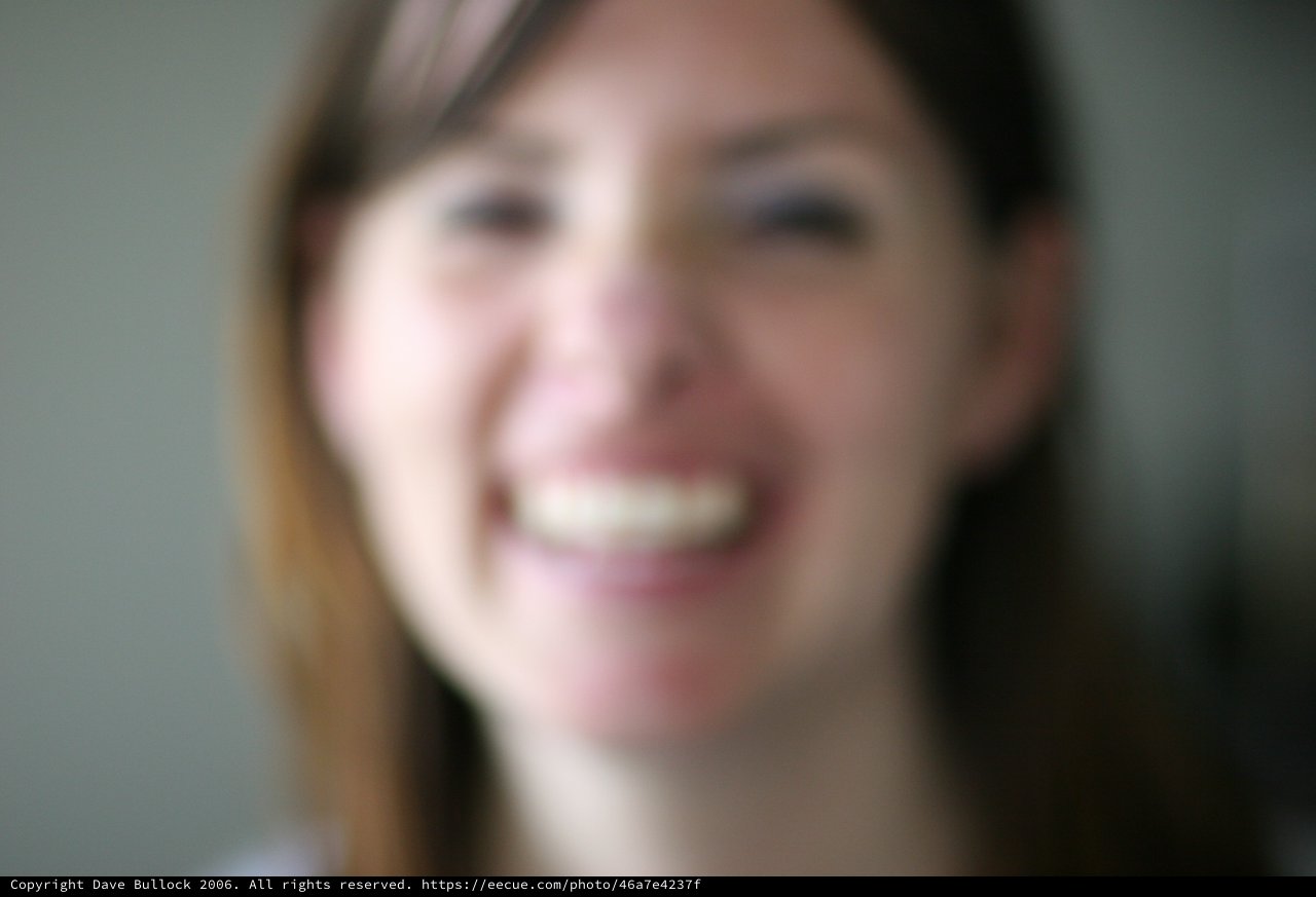 Blurred Portrait of a Smiling Young Woman