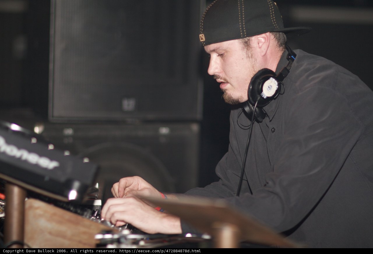 DJ Travis B rocks the turntables in his signature cap