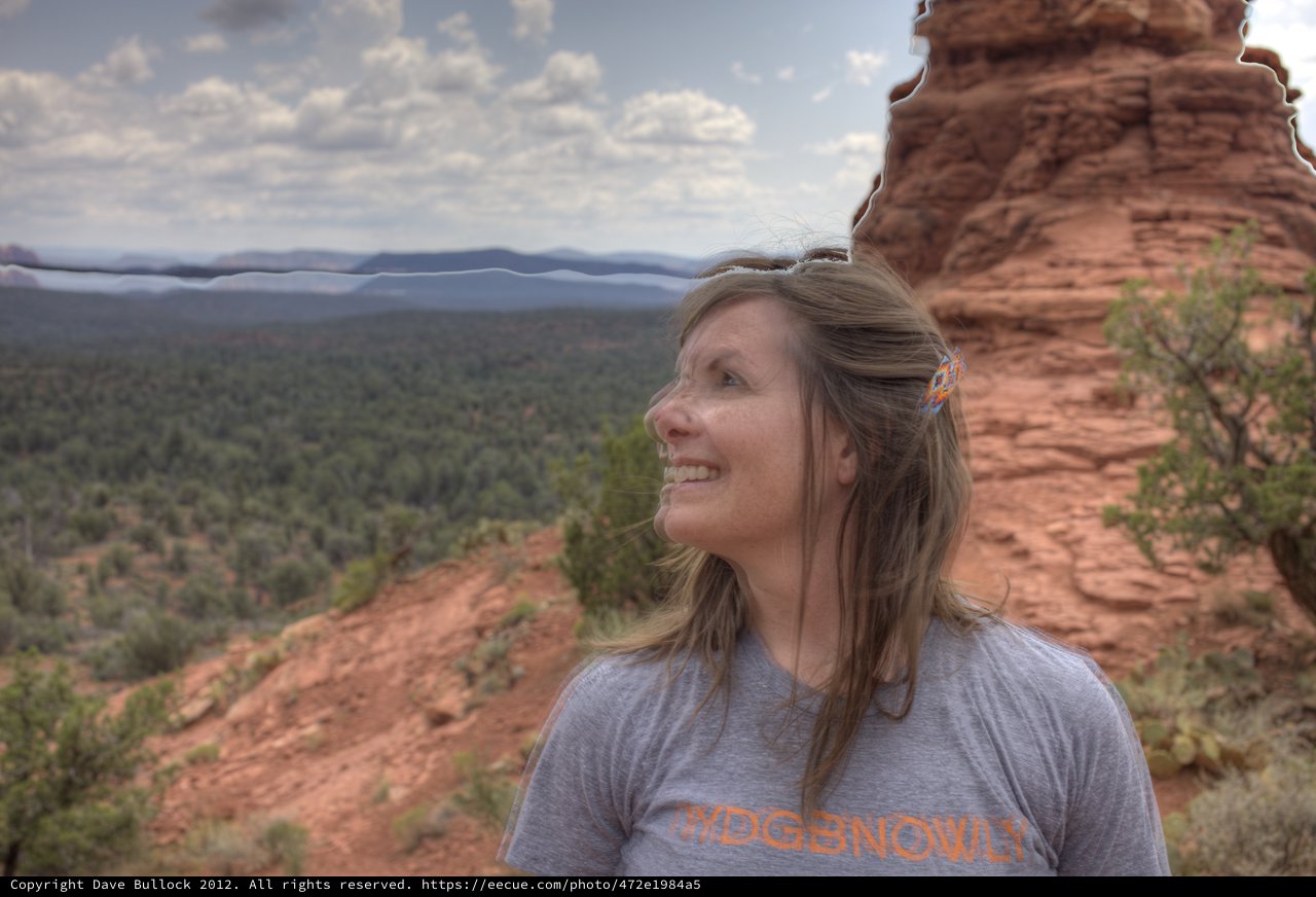 Woman Smiling Atop Red Rock Formation in Sedona