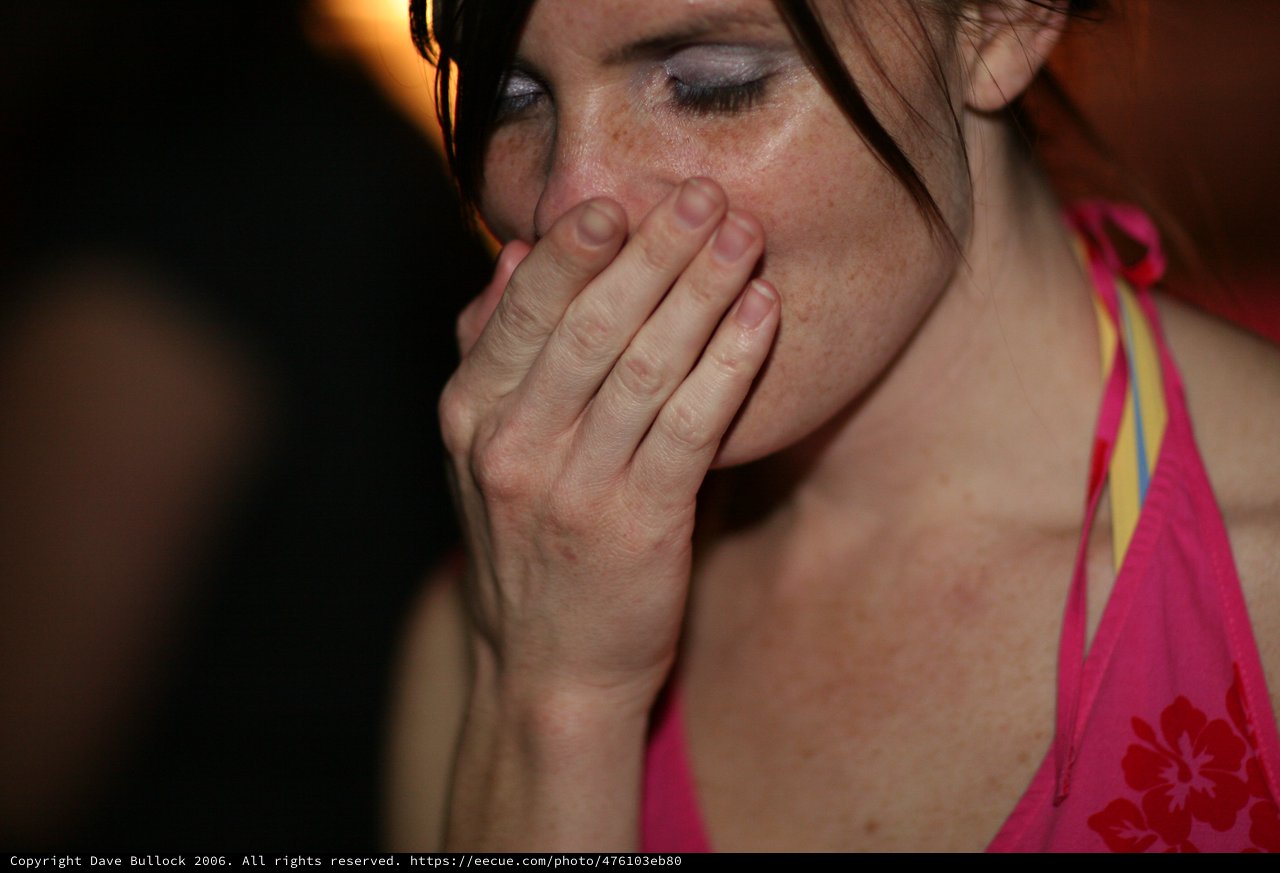 Woman in Distress Covering Her Mouth at Night