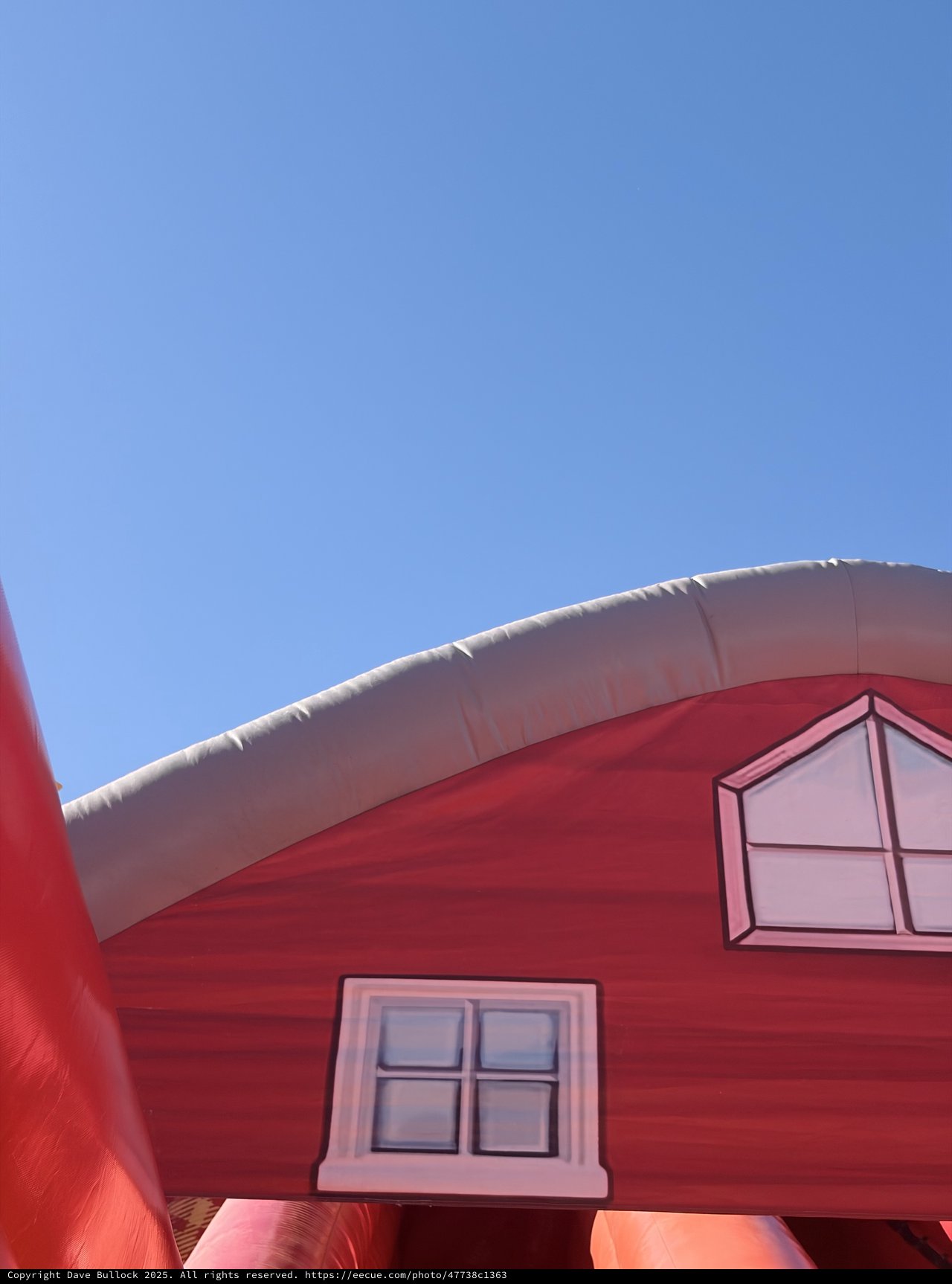 Inflatable Pink House Bouncer Against Blue Sky