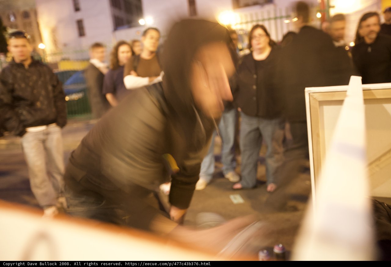 Hooded Figure on Plywood Wall